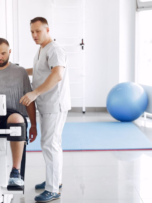 Patient has a rehabilitation in physiotherapy clinic. Doctor in a uniform.