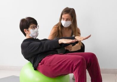 woman-training-fitness-ball-while-wearing-medical-mask