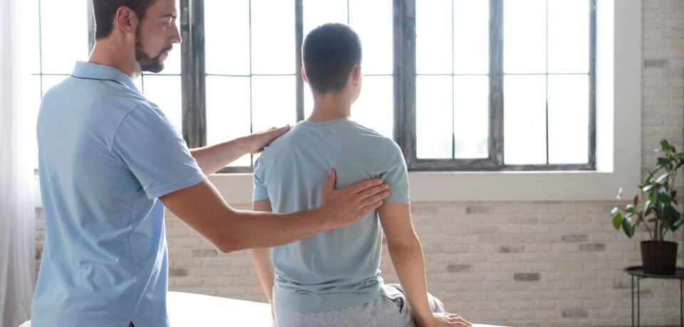 man-helping-patient-physiotherapy-medium-shot Posture Correction Physiotherapy - AR Clinics Islamabad